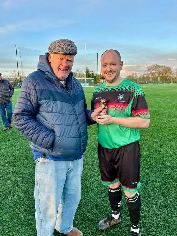 Ben Gourley receiving his McAleavey Cup *Man of the Match* trophy from League Secretary Ivan Bell